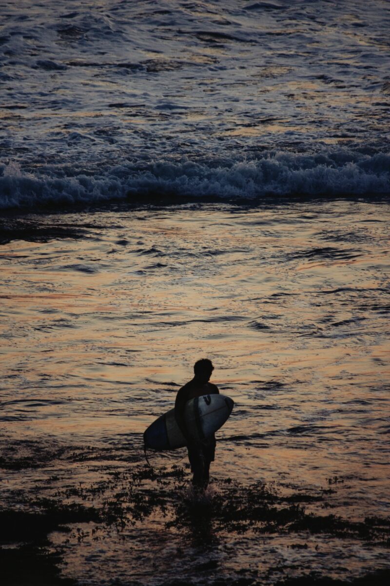 Surfer under the Tanah Lot Temple